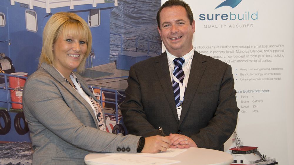 Sharon Mainprize from Mainprize Offshore and Nick Warren, managing director of Burgess Marine, sign the paperwork at Seawork 2015 for a second wind farm support vessel to be built by Burgess Marine for Mainprize. The hand over for the first completed vessel was also signed at Seawork 2015 in Southampton