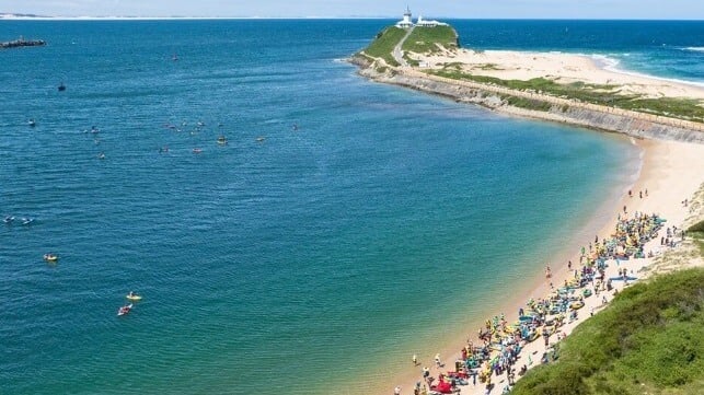 Activists on the beach and the water at the "protestival" (Rising Tide)