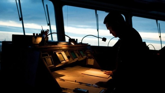 seafarer at chart table on bridge