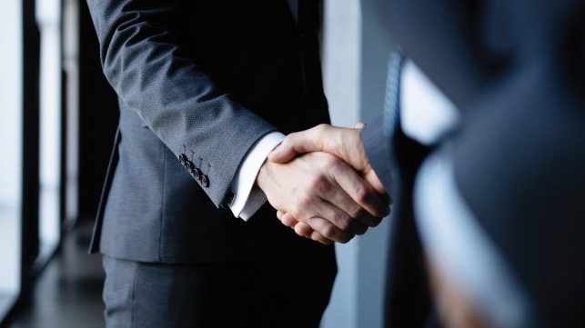 Handshake between two people in suits