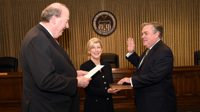 Chairman Khouri (left) administers oath of office to Commissioner Bentzel (right) who is joined by his wife, Suzanne Bentzel (center)