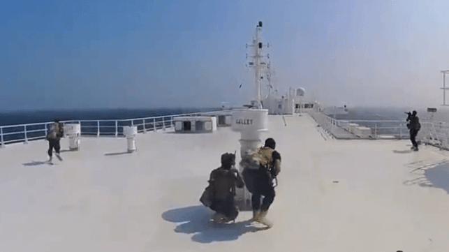 Houthi fighters advance along the top deck of the hijacked ship Galaxy Leader (Houthi Military Media)