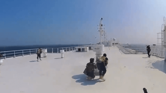 Houthi fighters advance along the top deck of the Galaxy Leader (Houthi Military Media)