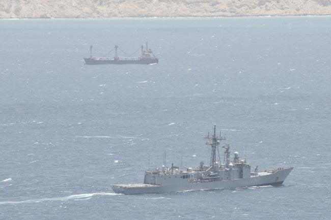 warship monitoring hijacked merchant ship