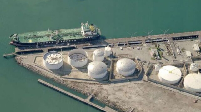 Tankers use funnel caps to filter exhaust gases at the Shell terminal in Los Angeles