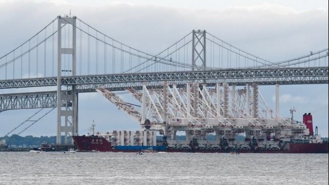 cranes maneuvering under bridges during arrival in Baltimore