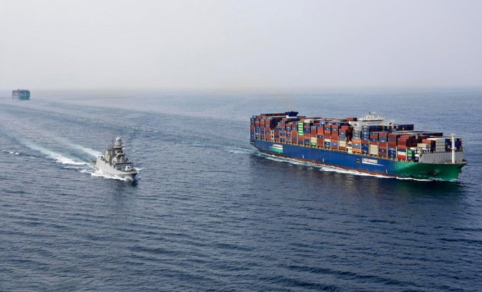 warship escorting containership in the Red Sea