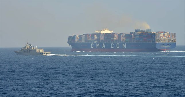 containership with warship escort