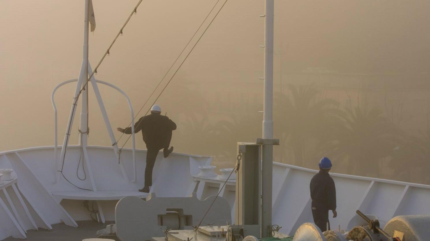 Crewmen on ship bow