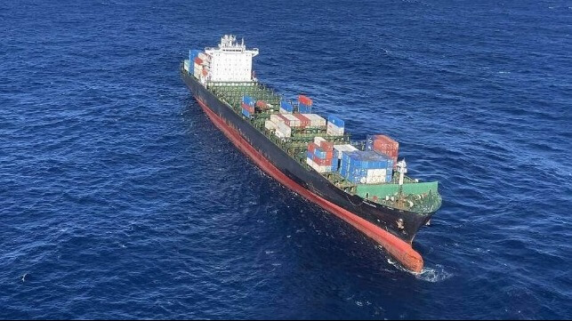 disabled boxship under tow