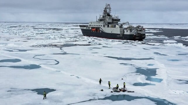 Researchers collect ice samples, while colleagues on board the research ship Kronprins Haakon keep watch for polar bears. Photo: Daniel Albert, SINTEF.