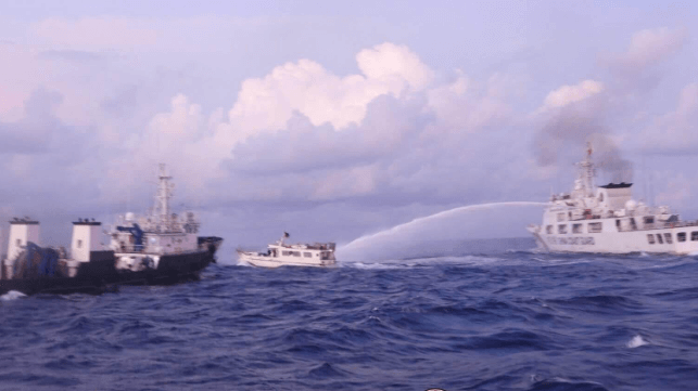 A China Coast Guard cutter water-cannons a small Philippine supply boat near Second Thomas Shoal, 2023 (file image courtesy Philippine Coast Guard)