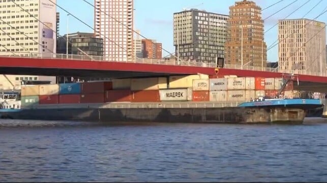 Barge stuck under bridge