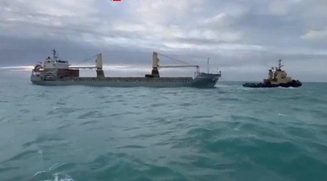 merchant ship being towed after engine failure