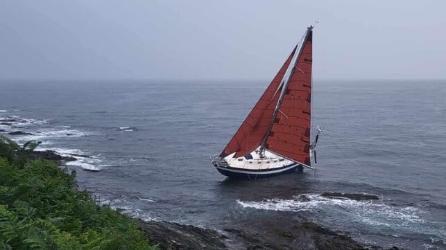 A yacht with sails still set was found grounded high on the rocks off Cornwall; when the tide went out, it was left high above the water (HM Coastguard)