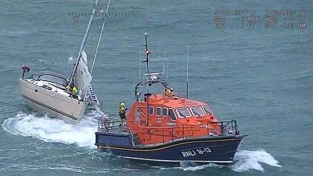 RNLI lifeboat rescuing a yacht in severe conditions