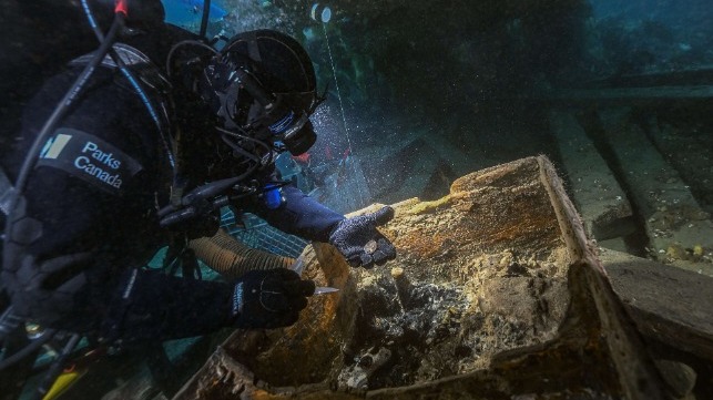 Parks Canada diver searches an abandoned sea chest