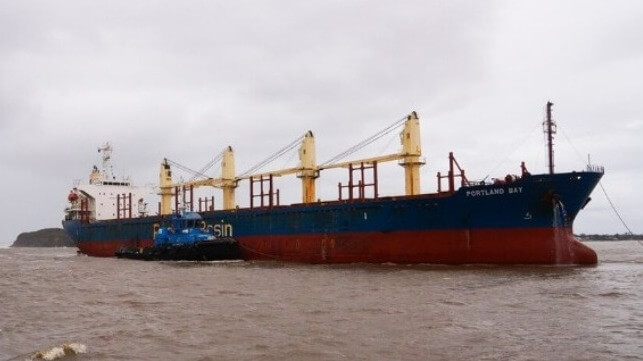 disabled bulker towed from storms into port