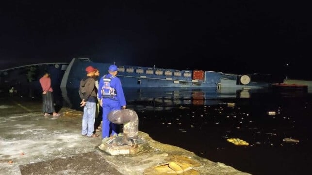 Capsized ferry at a port in Borneo at night