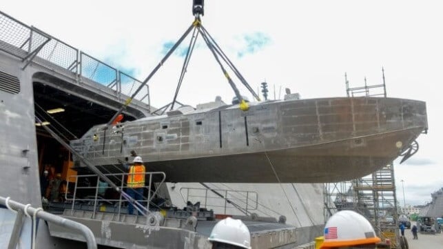 Sailors load a mine countermeasures drone boat into the hangar aboard a U.S. Navy LCS, 2025 (USN)