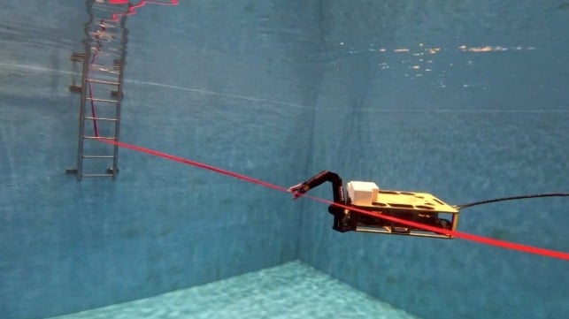 From within the ORL’s tank, ROV Rhody cuts the ribbon. (URI Photo: Inner Space Center)